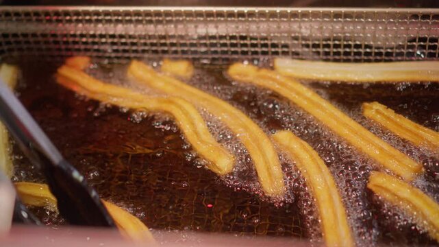 Churros that get turned in hot oil while baking