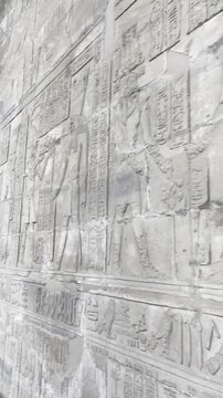 Sacred knowledge imparted by the sacred scribes of Edfu as you examine the hieroglyphic texts adorning the walls of the temple of Horus.
