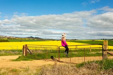 Woman looks out over her farming fields