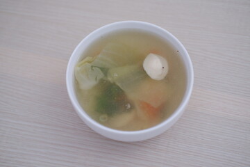 A bowl of soup on a wooden table