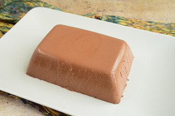Dark chocolate milk pudding cake  served on a plate. Selective focus