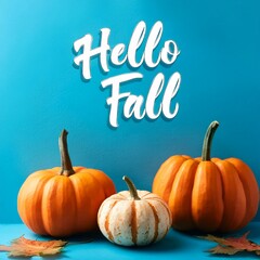 hello fall message with pumpkins on a blue background