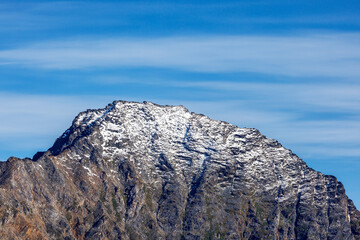 Mountain top and blues sky in Liverpool land, Northeast Greenland National Park, the peaks are covered with a sprinkling of light snow. Space for text. © Rixie