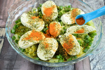 Prepare making broccoli casserole with mozzarella, spring onion and paprika powder