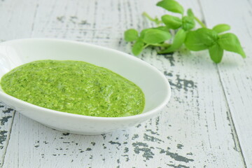 bowl of basil pesto, selective focus. White background