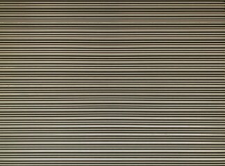 Old beige metal roller shutters door. Line pattern texture aluminum doors background. Old beige metal background texture.