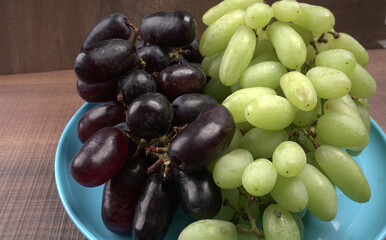 Natural organic different types of fresh ripe juicy grapes and space for text on table. top view, Agriculture concepts.