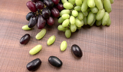 Natural organic different types of fresh ripe juicy grapes and space for text on table. top view, Agriculture concepts.