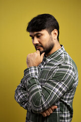 Obraz premium man with hand on chin, thoughtful and looking down