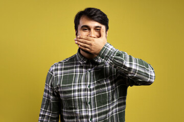 man covering his smile with his left hand