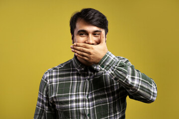 Fototapeta premium man covering his smile with his left hand and looking to the side