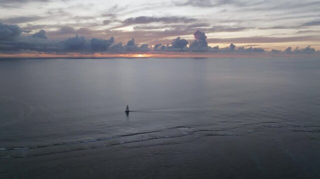 Aerial footage of tropical sunset on an siland withj ocean and boats. Mauritius