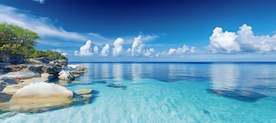 Obraz premium Idyllic White Sand Beach with Crystal Clear Turquoise Water, Blue Sky and Lush Green Vegetation