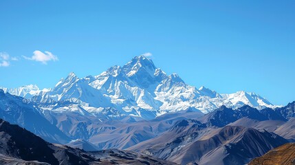 Fototapeta premium A snow-capped mountain peak stands out against a clear blue sky.
