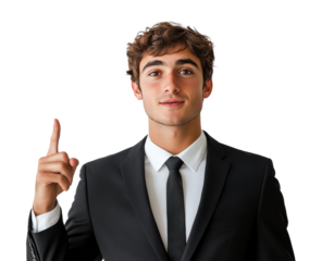 Young man in a suit gestures confidently while standing against a plain wall indoors