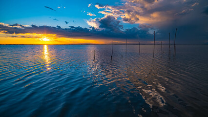 Cloudy sunset. View from the coast towards sea. Italy.