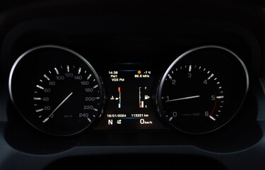 Modern car close up view of speedometer display in car dashboard panel. Meter st constant speed...