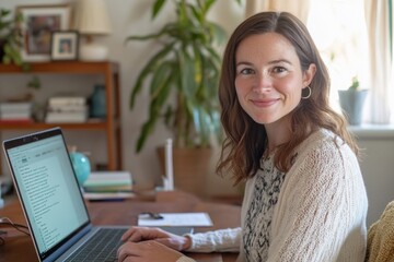 Smiling woman working remotely on laptop at home office with plants