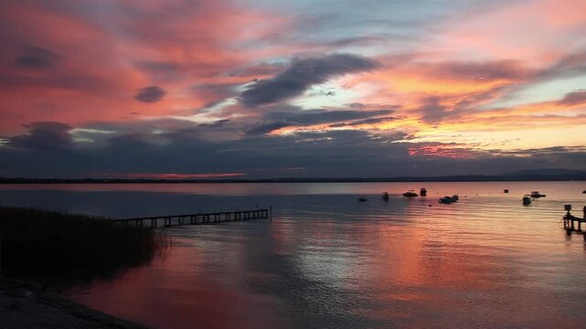 Panoramic lakeview at sunset from lakeside walkway at Pacengo, Lazise, Lake Garda, Italy