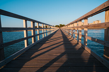The planked passage to the coast on the seashore during the golden hour at dawn