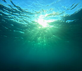 light diffraction and sun rays seen from undersea. underwater sunshine