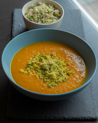 Carrot Soup with Coconut in a Blue Bowl - Close-Up