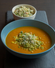 Carrot Soup with Coconut in a Blue Bowl - Close-Up