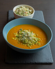 Carrot Soup with Coconut in a Blue Bowl - Close-Up