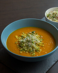 Carrot Soup with Coconut in a Blue Bowl - Close-Up
