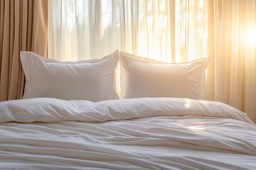 A comfortable, inviting bed with white pillows and bedding, illuminated by warm morning sunlight filtering through curtains