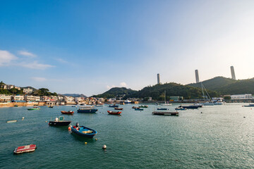 A row of traditional buildings in fishing village at Yung Shue Wan in Lamma Island, with boats in the foreground