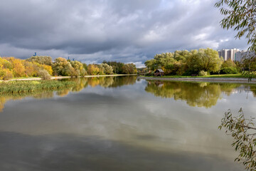 View of the Altufyevsky pond and residential buildings on the Altufyevsky highway. Lianozovo district, Moscow