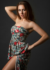 Fototapeta premium Beautiful sexy woman in a casual everyday dress, woman lifting up her dress reveals perfect beautiful legs, hot skin