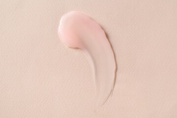 Smear of cosmetic product on beige background, top view