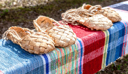 Wicker bast shoes  on the vintage homespun doormat