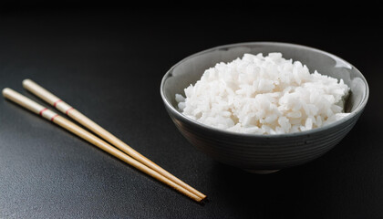 Natural cooked Japanese rice in ceramic bowl with chopstick. Healthy and tasty food. Delicious meal