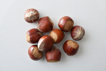 Heap of hazelnuts in shell isolated on white table
