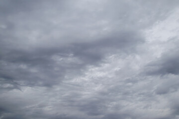 Gray rain clouds loaded with rain in the sky. Beautiful dark dramatic sky with storm clouds before rain or snow