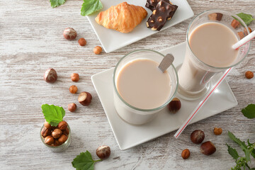 Breakfast prepared on table with glasses with refreshing hazelnut drink