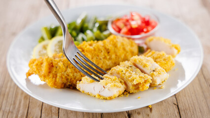 crispy fried chicken fillet with salad
