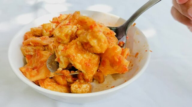 Close-up. Balado chili with a mixture of tofu and pete with white plate for lunch. 
