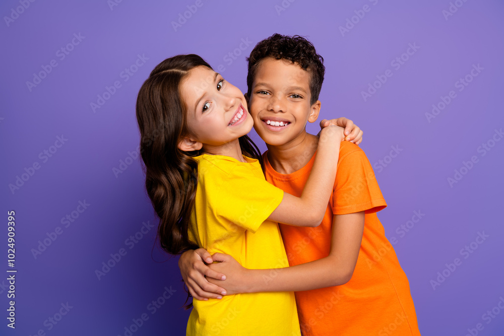 Poster Portrait of two little kids good mood cuddle wear t-shirt isolated on violet color background