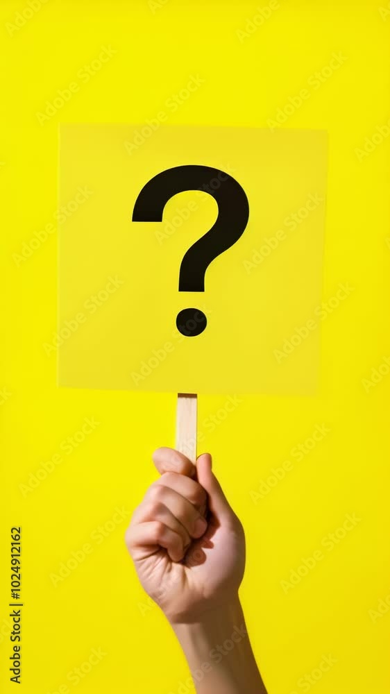 Poster hand holding a bright yellow sign with a bold black question mark symbolizing doubt and curiosity. e