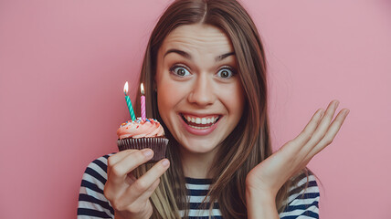 Happy woman holding birthday cupcake, pink and brown, joyful celebration, birthday party. 
