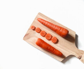 Fresh carrots on the cutting board. Isolated background
