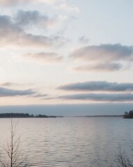 Fototapeta premium Serene Dawn Over Lake with Low Hanging Clouds.