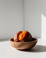 Boiled sweet potato served in a wooden bowl.
