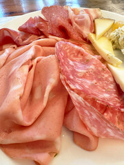 Assorted italian meat and cheese platter with mortadella and salami