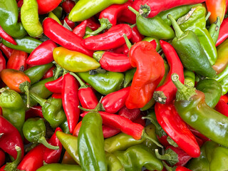 Colorful heap of red and green peppers at a farmer's market