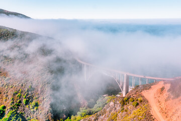 Beautiful scenery of Pacific Ocean coast along Highway 1 and Big Sur, wonderful aerial view of Bixby Bridge, sunset, sunrise, fog. Concept, travel, vacation, weekend